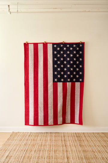 Red, white, and blue blanket with American flag design featuring vertical stripes and star-filled canton section.9