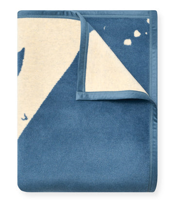 Folded blue and cream blanket with map design and stitched binding edges.7