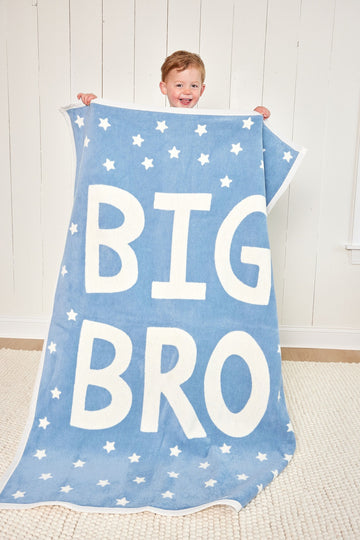 Blue midi blanket with white stars and "BIG BRO" text, held by a toddler.2