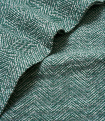 Evergreen woven shawl with herringbone texture pattern and draped folds.6