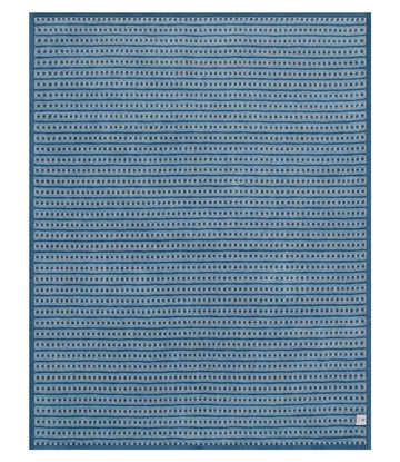 Cornflower blue blanket with repeating rows of small circular pebble pattern throughout.7