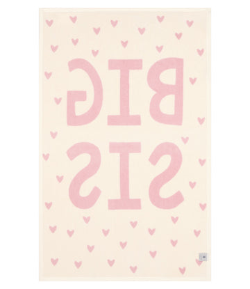 Cream blanket with pink "BIG SIS" text and scattered heart pattern throughout.9