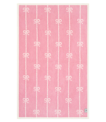 Pink midi blanket with white vertical stripes and repeated bow motifs throughout.8
