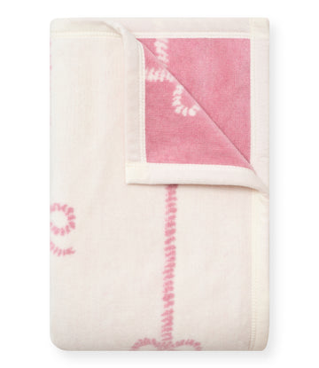 Cream and pink midi blanket with buoy bow pattern, folded to show reversible sides with cream binding.7