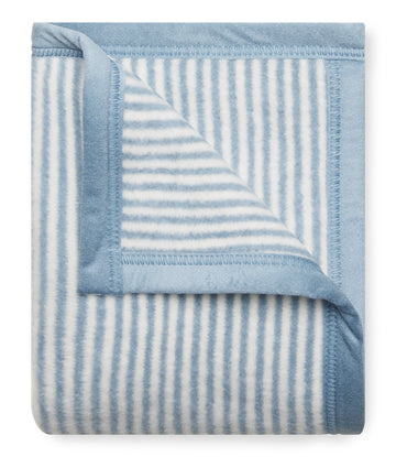 Blue and white striped mini blanket with bound edges and folded corner detail.10