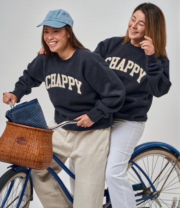 Navy crewneck sweatshirt with "CHAPPY" text across chest, worn by two people.5