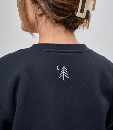 Navy crewneck sweatshirt with small white tree and moon embroidery on back.3