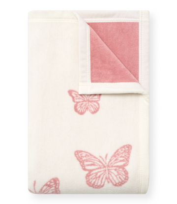 Cream blanket with pink butterfly motifs and pink quilted reverse side with white binding.6