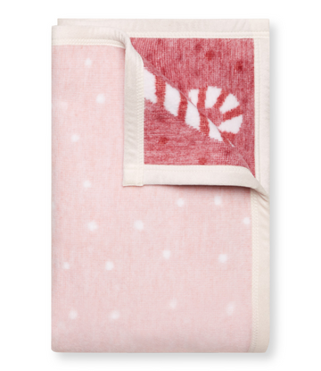 Pink midi blanket with white polka dots and red candy cane patterned corner section with cream binding.6