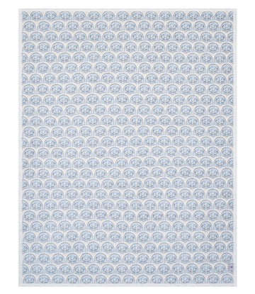 Blue and white blanket with repeating scallop shell pattern throughout.8