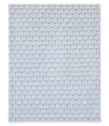 Blue and white blanket with repeating scallop shell pattern throughout.3