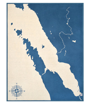 Blue and cream map blanket showing Door County peninsula with compass rose in lower left corner.5