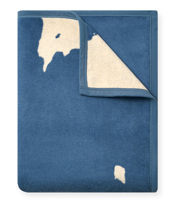 Blue fleece blanket with cream-colored Door County map outline and matching triangular corner detail.4