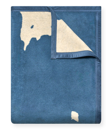 Blue wool blanket with cream Door County peninsula map outline and small island detail on front, cream reverse side visible.4