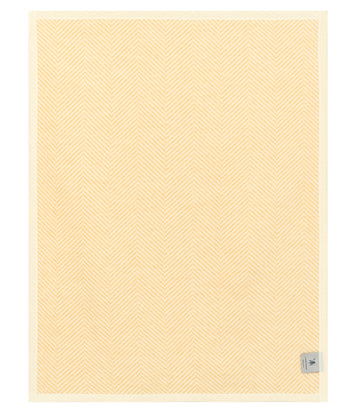 Butter yellow blanket with herringbone weave pattern and rectangular shape.7
