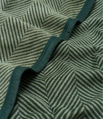Forest green blanket with herringbone stripe pattern and bound edge detail.5