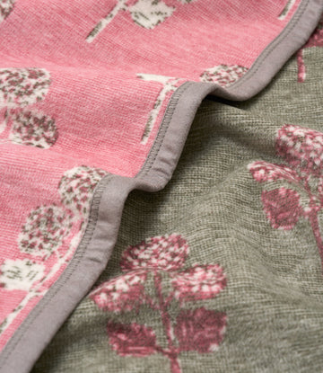 Pink and gray blanket with cream and mauve blockprinted hydrangea flowers, gray binding on edge.5
