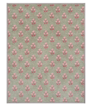 Sage green blanket with repeating pattern of pink hydrangea flowers printed throughout.4
