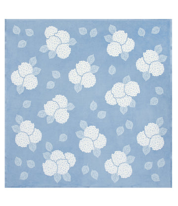 Blue blanket with white hydrangea flower clusters and leaf pattern throughout.3