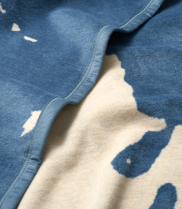 Blue and cream blanket with Lake Tahoe map design and stitched binding edge detail.3