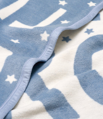 Blue and white mini blanket with star pattern and sewn binding edge detail.4