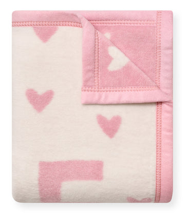 Pink and white reversible mini blanket with heart pattern and whipstitched edges.9
