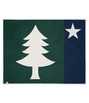Rectangular blanket with green left half featuring white pine tree and dark blue right half with white star.5
