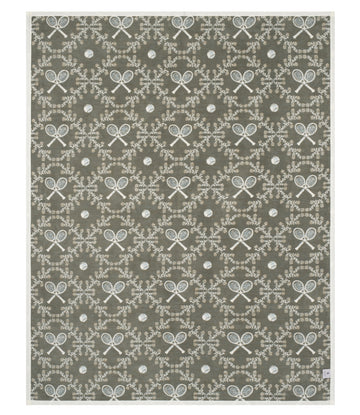 Olive green blanket with white tennis rackets, balls, and ornamental leaf wreath pattern throughout.8