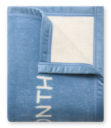 Blue and cream fleece blanket with "MILESTONE" text and binding, shown folded with corner detail.8