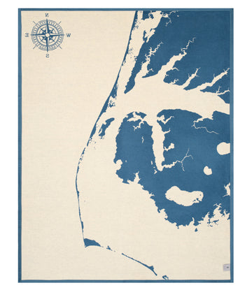 Cream and blue blanket featuring Outer Banks map with compass rose and nautical coastline details.5