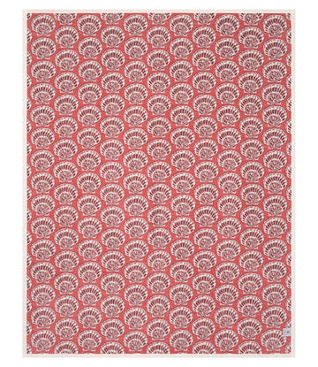 Red blanket with repeating white shell pattern throughout.8
