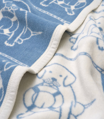 Blue and cream blanket with sailor dog pattern and white binding edge detail.3
