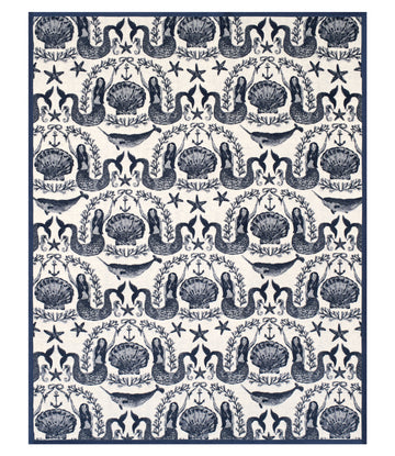 Cream and navy blanket with repeating pattern of sirens, shells, starfish, anchors, and seaweed.2