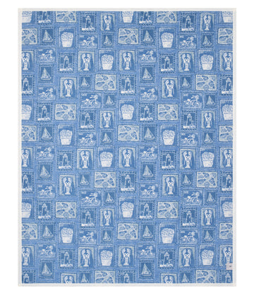 Blue blanket with repeating white stamp-style icons of sailboats, lighthouses, baskets, and coastal scenes in a grid pattern.8