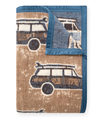 Tan and blue woven blanket with vintage surf wagon pattern and navy blue binding.6