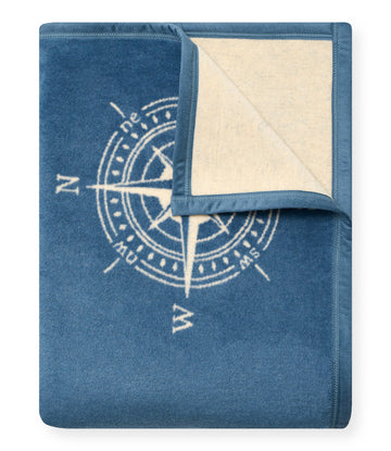 Blue blanket with cream-colored reverse side and compass rose design printed in light blue.5