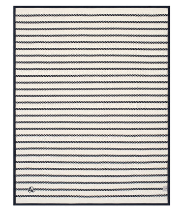 Cream and navy diagonal striped blanket with dark border and knotted detail at bottom corner.7