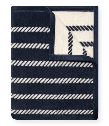 Navy and cream wool blanket with horizontal rope-knot pattern and folded corner detail.5