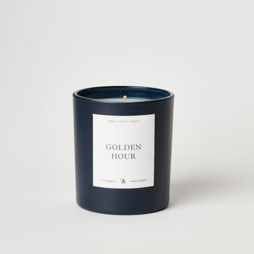 Dark navy cylindrical candle with white label reading "Golden Hour" and single wooden wick.3
