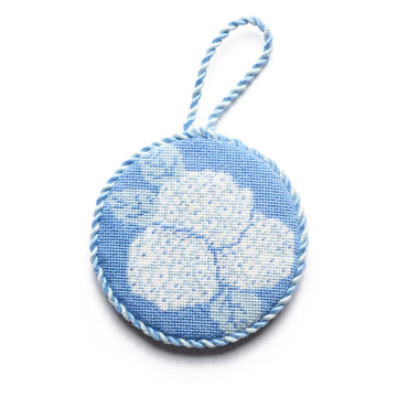 Circular needlepoint ornament with blue and white hydrangea flower design and twisted cord loop.5